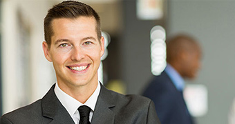 Man in business suit with man woman in background