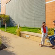 Two Edward Jones's workers sitting outside of Corporate south buiding