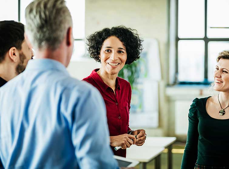 Woman interacting with work colleagues