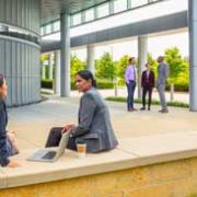 Workers gathering outside having discussions.