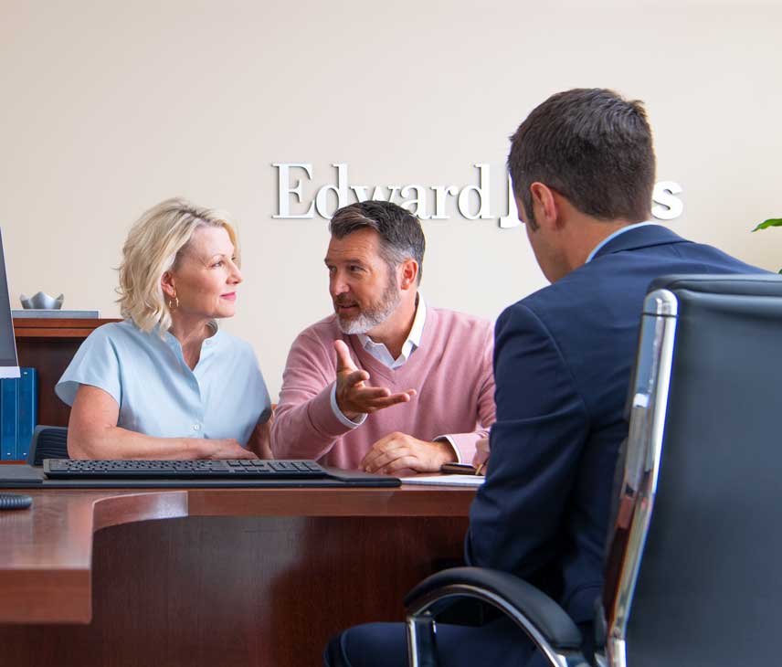 NFA856x730 A couple having a discussion with a professional man in Edward Jones office.