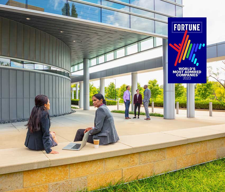 Coworker outside having discussions. with Fortune Most Admired Company 2023 logo on top.