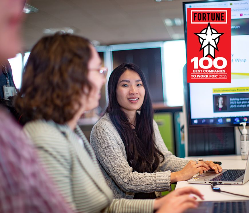 Two women participating in a meeting with the fortune 100 , Best places to work logo on the image.