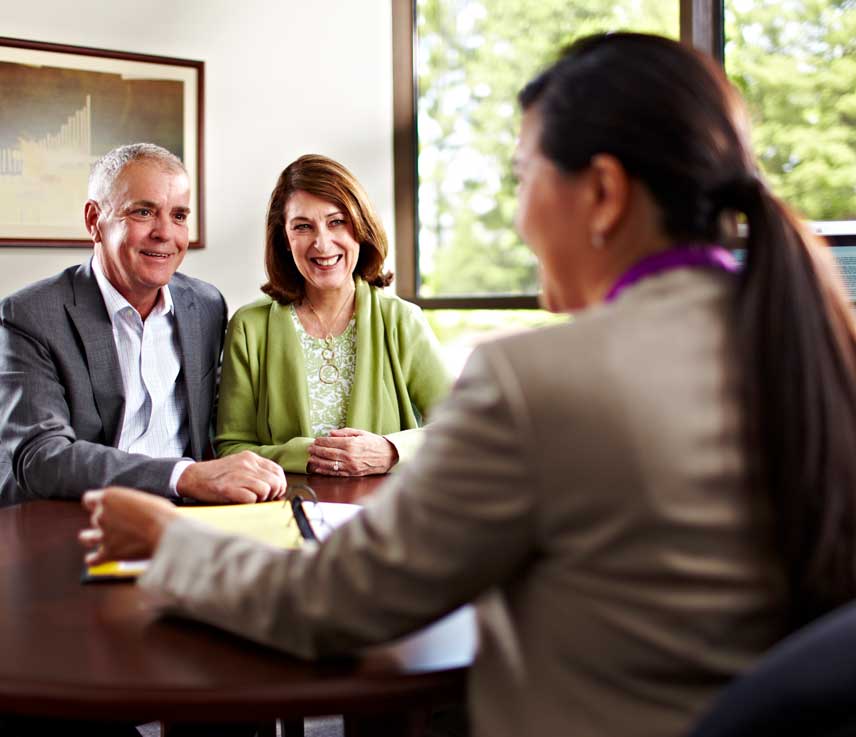 A couple meeting with professional woman.