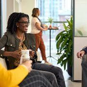 Two women and a man sitting discussing in an Edward Jones office.