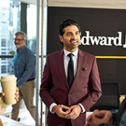 a group of people speaking in an Edward Jones office