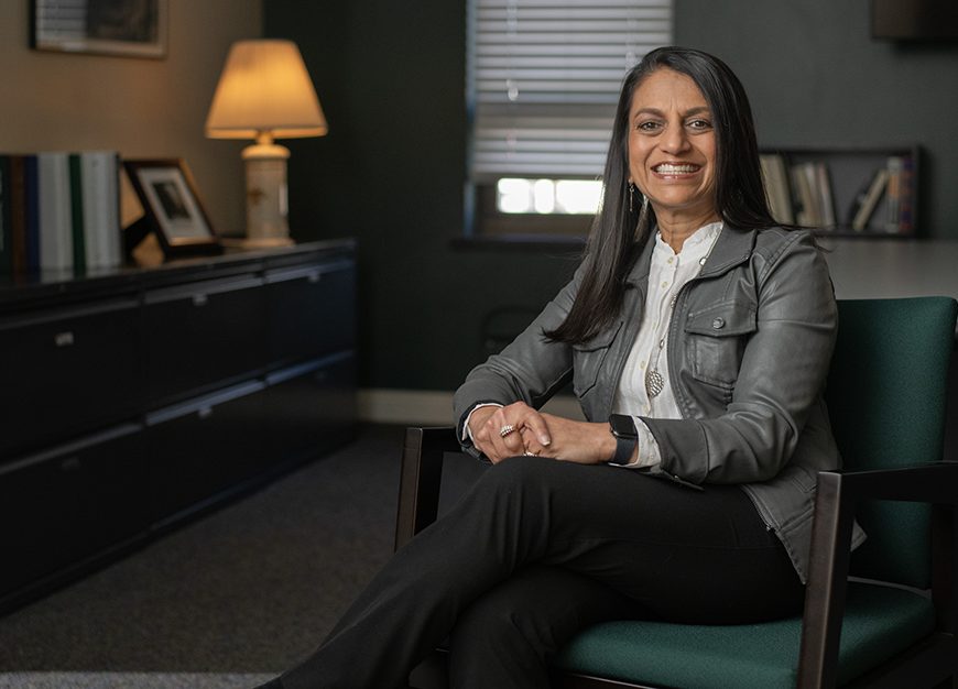 Binita Kraus sitting in a chair smiling.