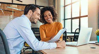 Two business professionals discussing at a table.