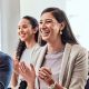 Group of advisors clapping facing a presentation.