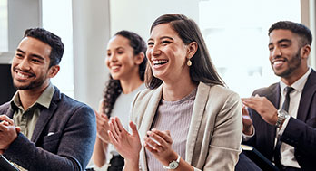 Group of advisors clapping facing a presentation.