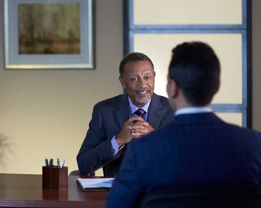 Two professional men having a discussion in an office.