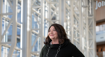 Woman smiling inside Edward Jones Corporate building.