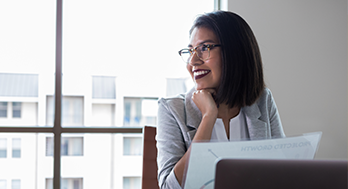Business woman looking happy at work.