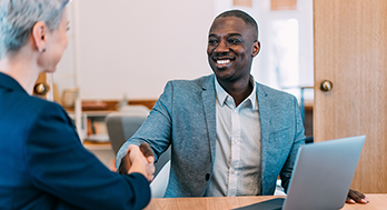 A man shaking hand with a woman.