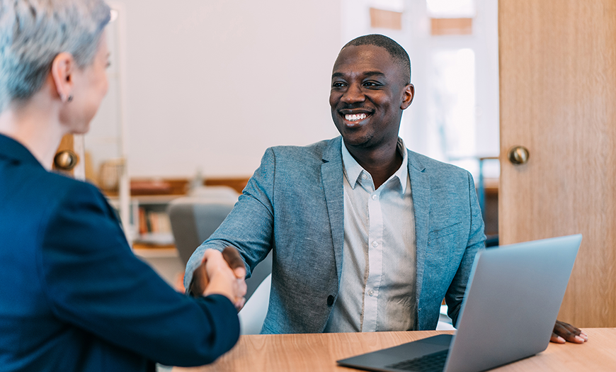 A man shaking hand with a woman.