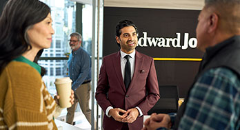 a group of people speaking in an Edward Jones office