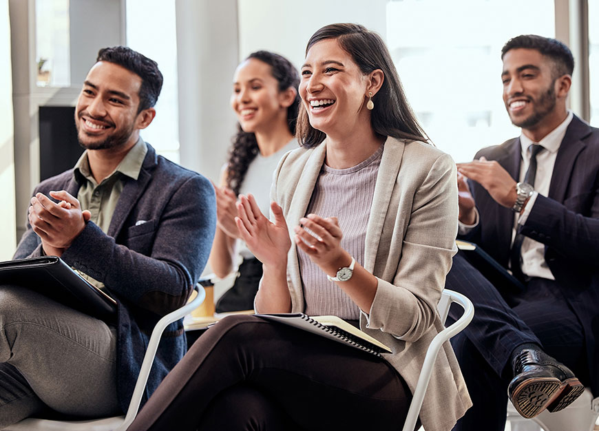 Group of advisors clapping facing a presentation.