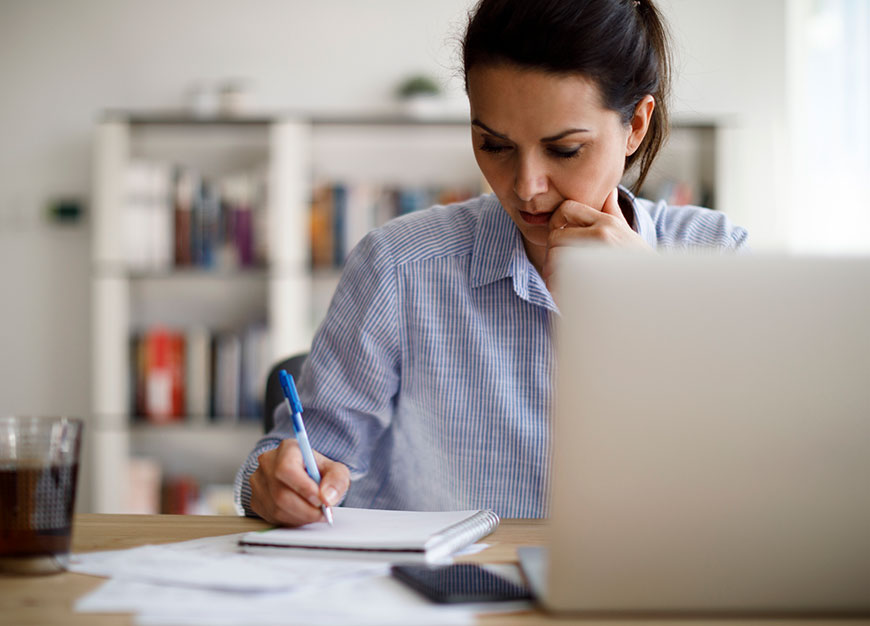 mature women working on a dining table.