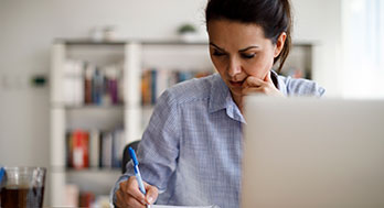 mature women working on a dining table.